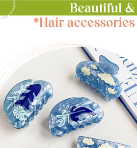 Detail showing blue acetate hair claws with cloud, fishbone and floral patterns