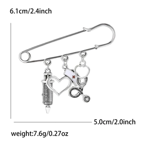 Silver alloy medical brooch pin featuring syringe heart and stethoscope charms