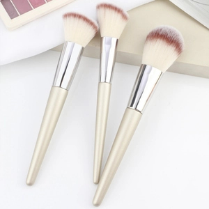 Detailed view of powder brushes with gradient bristles and champagne gold pointed handles
