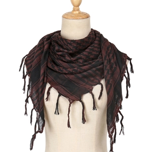 Close-up of black and brown houndstooth pattern scarf with delicate fringe details