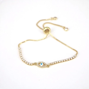 Detailed view of gold-toned Evil Eye bracelet with pavé rhinestones and adjustable closure