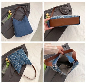 Detail view of denim shoulder bag featuring frayed edges, tassels, and a brown leather strap