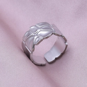 Close-up of adjustable stainless steel ring with embossed basketball texture details