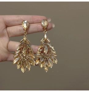 Detailed view of luxury teardrop chandelier earrings with champagne crystals