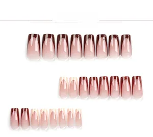 Detail view of reddish-brown and nude pink French gradient long square press-on nails