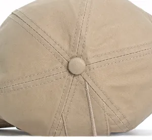 Macro view of khaki cotton baseball cap top button and precision reinforced stitching