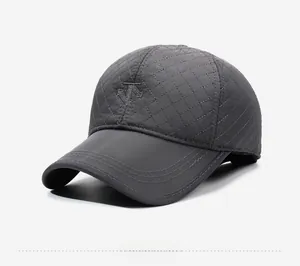 Detail view of the quilted diamond pattern and embroidered logo on the gray baseball cap
