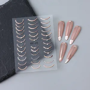 Autocollants d'ongles 5D gaufrés avec courbes en or rose et détails en strass