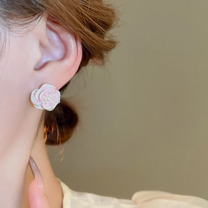 Detail of pink enamel rose earring with white pearl and micro-inlaid crystals