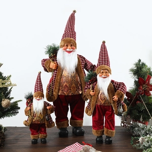 Standing Santa Claus figurines with red cloaks and plaid details for Christmas decor