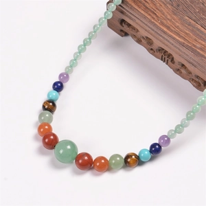 Detail of colorful multi-stone beaded necklace featuring natural agate and quartz crystals