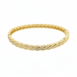 Elegant gold plated twisted cable bangle featuring micro-pave cubic zirconia accents