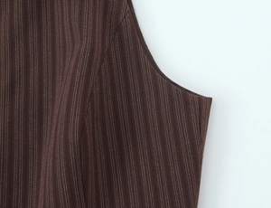 Detailed close-up showing the precise stitching and brown pinstripe woven fabric detail