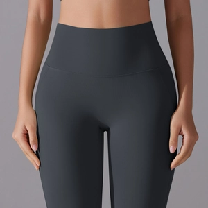 Detailed view of high-waist seamless dark grey yoga leggings with matte compression fabric