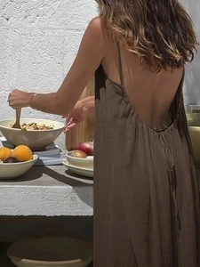 Detailed back view of brown backless maxi dress with fine pleated texture and thin straps