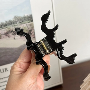 Minimalist black wave acetate shark clip hair claw accessory with golden spring