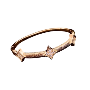 18K rose gold plated cuff bracelet featuring brushed texture and sparkling star motifs
