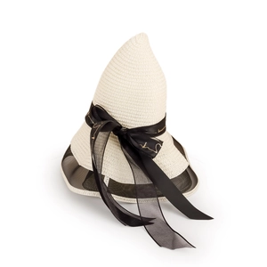 Detail of beige straw sun hat featuring elegant black satin bow and mesh brim trim