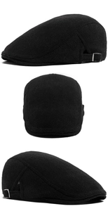 Detail of black herringbone flat cap featuring thick wool texture and metal side buckles
