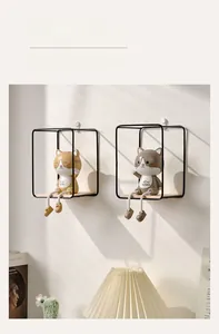 Detail of Nordic wall shelves with decorative cats on a wooden base and black iron frames