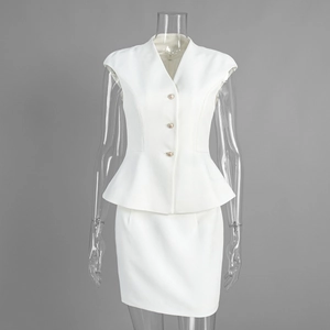 Detail of white two-piece peplum top with V-neck and metal buttons with matching skirt
