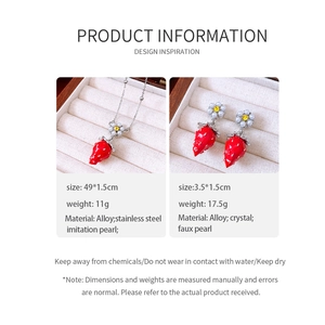 Detailed view of red strawberry pendant necklace and earrings with pearl specs and size info