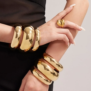 Polished gold stainless steel wide bangles and textured heart ring set for women