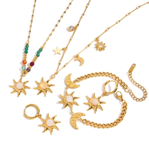 Elegant gold stainless steel jewelry set with sun and moon motifs on white background