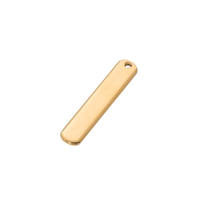 Macro detail of a polished gold rectangular stainless steel bar pendant for DIY engraving