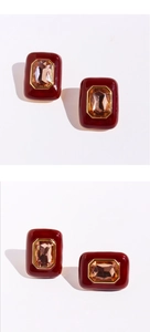 Macro detail of vintage red enamel square stud earrings with amber geometric stones