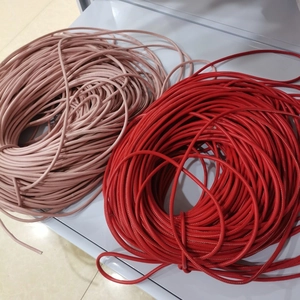 Detail of 6mm round braided leather cords in light pink and red for DIY bag accessories