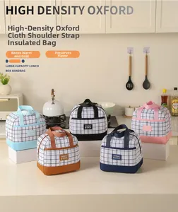Detailed view of insulated lunch bags in five colors with grid patterns and sturdy handles