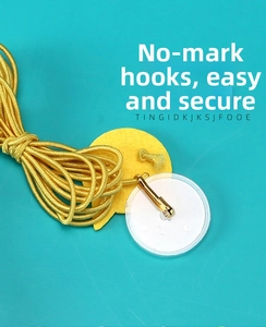 Detail of hanging cat toy hook component with golden elastic cord and suction cup