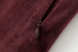 Close-up of wine red velvet fabric texture with high-quality invisible zipper detail