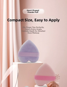 Close-up of heart-shaped flocking powder puffs in purple and pink with elastic straps