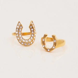 Detailed view of two 18K gold plated horseshoe rings with white zircon pave setting