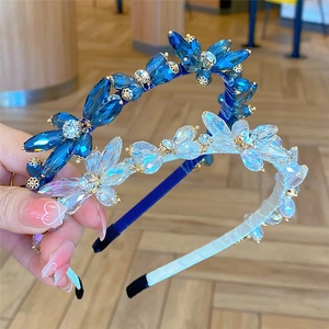 Detail shot of sparkling blue and white crystal headbands with fine metal frames