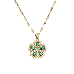 Golden five-petal flower pendant necklace with green and white gemstones on a lip chain