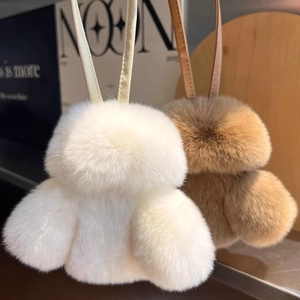 Plush fluffy faux fur duck keychains in white and brown with leather straps