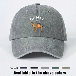 Détail de la broderie de chameau dorée sur une casquette de baseball en denim délavé gris