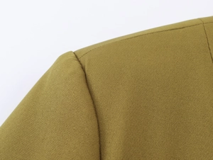 Close-up of khaki blazer shoulder stitching and woven fabric texture for women