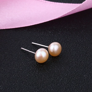 Elegant 925 sterling silver studs with round pink freshwater pearls on black texture