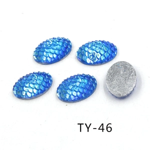 Detail of 13x18mm blue fish scale resin cabochons with iridescent AB finish and flat back