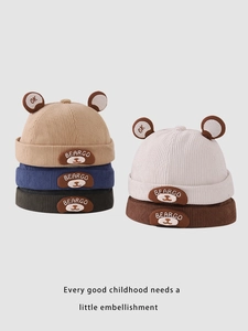 Close-up of children corduroy beanies with bear ears and embroidery in five colors