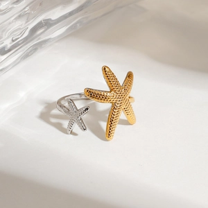 Detail of two-tone 18K gold and silver starfish adjustable open ring with texture