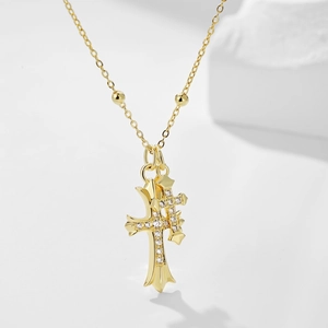 Detail of gold-plated double cross pendants with micro-inlaid zircons and bead chain
