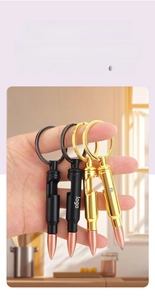 Close-up of a metal bullet-shaped keychain with integrated bottle opener function