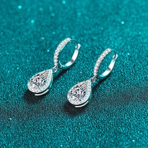 Elegant S925 sterling silver teardrop moissanite hoop earrings on teal glitter background