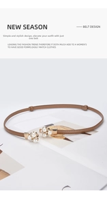 Detailed view of brown leather thin belt featuring a pearl and rhinestone gold buckle