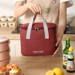 Waterproof burgundy insulated lunch bag with TEAST FOOD print and durable grey handles